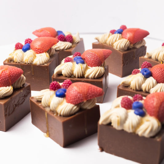 Handcrafted chocolate fudge soap bars topped with realistic fruit and cream decorations