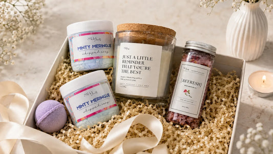 Salty Secrets Rakhi gift hamper under ₹1299 with handmade soap, whipped soap, bath bomb, bath salt and candle arranged as a self-care gift for sister.